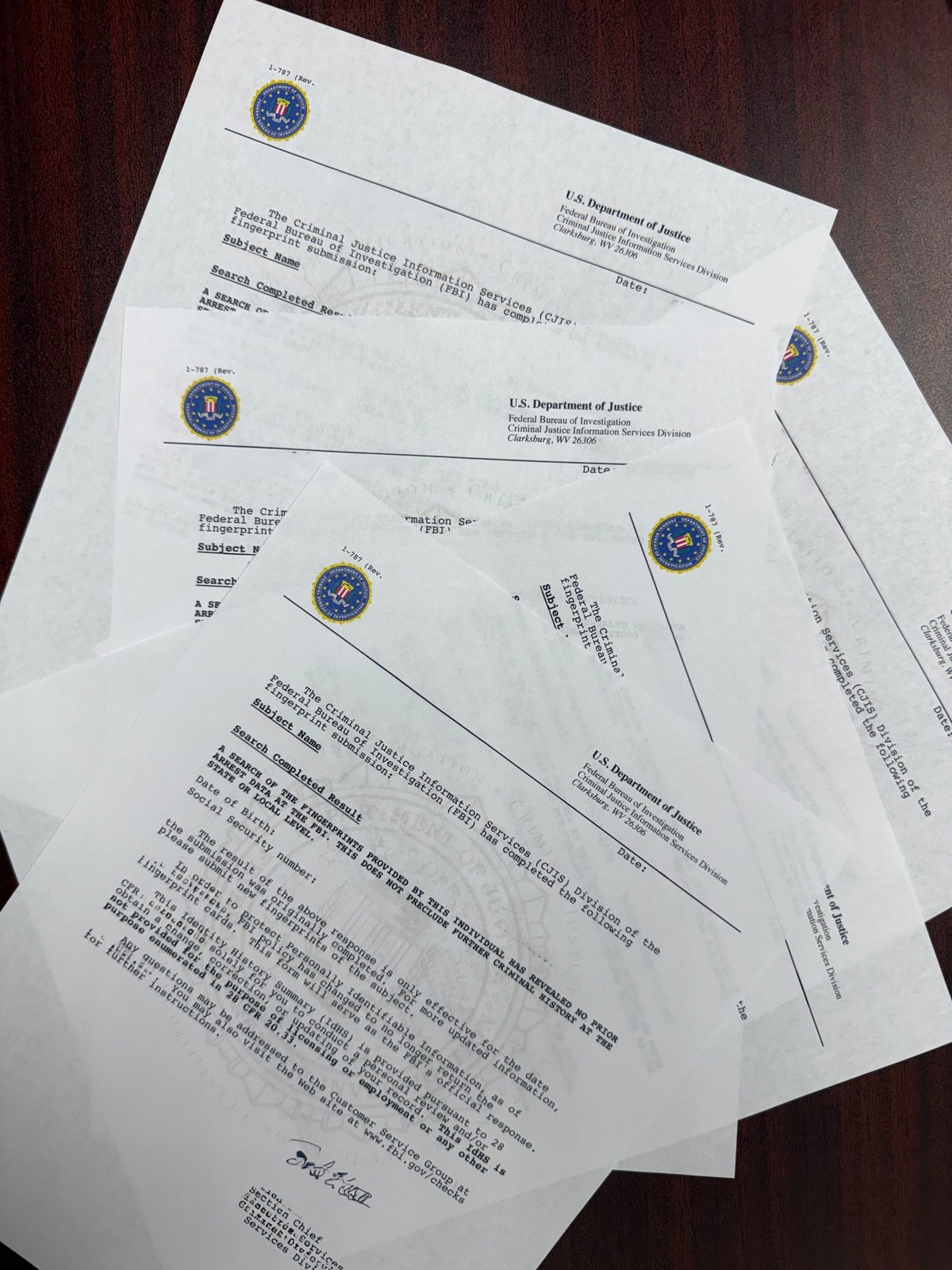 FBI Identity History Summary reports issued by the FBI Criminal Justice Information Services Division in Clarksburg, WV, showing the FBI seal letterhead, watermark and Section Chief signature